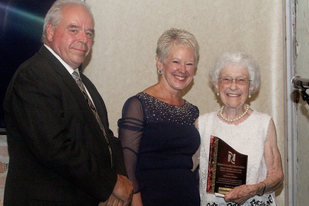 Jim Endress, Highland Board Chair, left, Chris Kuberski, Highland President, present the Lifetime Achievement Legacy Award to Marjorie Phillips at the Legacy Gala held at the Wagner House in Freeport.