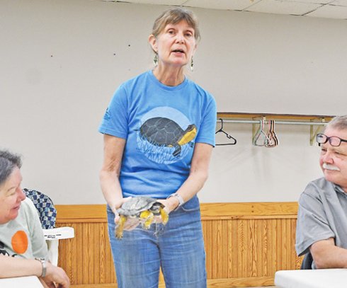 Rebecca Cristoffel displays turtle to audience