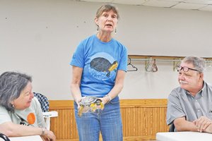 Rebecca Cristoffel displays turtle to audience
