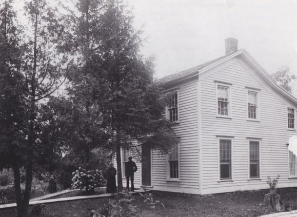 Almira Humes Churchill Robertson with her grandson, Frank Sykes (1864 - 1959), in front of the house that she lived in for more than 40 years.