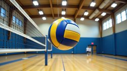 Generic volleyball flying over net in gymnasium
